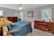 Comfortable bedroom features two dressers, two windows, a ceiling fan, and carpeted floors at 237 Walnut Point Dr, Matthews, NC 28105