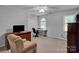 Comfortable bedroom featuring carpeted floors, neutral colored walls, and a tv at 237 Walnut Point Dr, Matthews, NC 28105