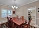 Inviting dining room with hardwood floors, chandelier, and a view into the kitchen at 237 Walnut Point Dr, Matthews, NC 28105