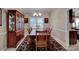 Elegant dining room featuring a large table, six chairs, and a china cabinet at 237 Walnut Point Dr, Matthews, NC 28105