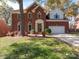 Charming two-story brick home with mature landscaping and a two-car garage at 237 Walnut Point Dr, Matthews, NC 28105