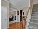 Bright foyer featuring hardwood floors, staircase, and an open view to living room at 237 Walnut Point Dr, Matthews, NC 28105