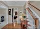 Inviting foyer with hardwood floors, stairs, and a glimpse of the kitchen at 237 Walnut Point Dr, Matthews, NC 28105