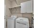 Convenient laundry area equipped with modern washer and dryer units and shelving at 237 Walnut Point Dr, Matthews, NC 28105