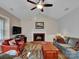 Spacious living room featuring a fireplace, ceiling fan, and hardwood floors at 237 Walnut Point Dr, Matthews, NC 28105