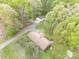 An aerial view of a home shows it is nestled among mature trees with a garage and long driveway at 2582 Ivey Church Rd, Lincolnton, NC 28092