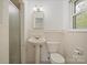 This well-lit bathroom features a pedestal sink and a glass-enclosed shower at 2582 Ivey Church Rd, Lincolnton, NC 28092
