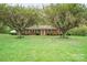 Beautiful brick home on a sprawling green lawn, framed by flowering trees at 2582 Ivey Church Rd, Lincolnton, NC 28092