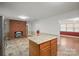 Open-concept kitchen featuring a center island, stainless steel refrigerator, and a brick fireplace at 2582 Ivey Church Rd, Lincolnton, NC 28092