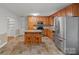 Practical kitchen with wood cabinets, stainless appliances, and a cozy island with seating at 2582 Ivey Church Rd, Lincolnton, NC 28092