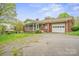 View of brick home featuring a screened porch and a spacious garage at 2582 Ivey Church Rd, Lincolnton, NC 28092