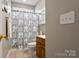 Cozy bathroom featuring a patterned shower curtain and neutral tile flooring at 2610 Flagstone Ct, Shelby, NC 28152