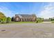Charming brick home with a well-maintained lawn and inviting front porch featuring classic rocking chairs at 2610 Flagstone Ct, Shelby, NC 28152