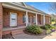 Charming front porch with classic brickwork, white columns, and comfortable rocking chairs, inviting relaxation at 2610 Flagstone Ct, Shelby, NC 28152