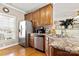 Well-appointed kitchen featuring granite countertops, wood cabinets, stainless steel appliances, and hardwood floors at 2610 Flagstone Ct, Shelby, NC 28152