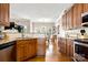 Open kitchen view with wooden cabinets and hardwood floors with view to dining room at 2610 Flagstone Ct, Shelby, NC 28152