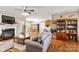 Open-concept living room with fireplace, hardwood floors, and ample natural light, connecting to dining area at 2610 Flagstone Ct, Shelby, NC 28152