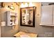 Bathroom with granite counter, mirror and storage at 2929 Matoka Trl, Matthews, NC 28104