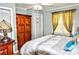 Bright bedroom featuring a ceiling fan, a wood wardrobe, and a neutral color scheme at 2929 Matoka Trl, Matthews, NC 28104