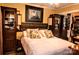 Bedroom with a decorative headboard, warm wall color, and built-in cabinets at 2929 Matoka Trl, Matthews, NC 28104