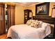 Comfortable bedroom featuring a decorative headboard, floral pillows, and wood floors at 2929 Matoka Trl, Matthews, NC 28104