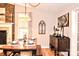 Charming dining area showcases a brick fireplace, a wooden table and bench set, and decor at 2929 Matoka Trl, Matthews, NC 28104
