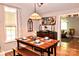 Warm and inviting dining area featuring a wooden table, bench seating, and stylish decor at 2929 Matoka Trl, Matthews, NC 28104