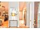 Inviting entryway featuring neutral paint, stylish console table, and seamless transition into the kitchen and dining area at 2929 Matoka Trl, Matthews, NC 28104