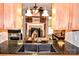 Kitchen view reveals hardwood floors, brick fireplace in the living room and natural wood cabinets at 2929 Matoka Trl, Matthews, NC 28104