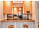Kitchen island featuring a black countertop, bar seating, pendant lighting, and plenty of cabinet space at 2929 Matoka Trl, Matthews, NC 28104