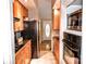 Galley kitchen with black appliances and wood cabinets at 2929 Matoka Trl, Matthews, NC 28104