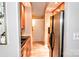 Galley kitchen featuring wood floors, light wood cabinets, stainless steel appliances, and ample storage at 2929 Matoka Trl, Matthews, NC 28104