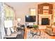 Bright living room featuring a fireplace, hardwood floors, and comfortable seating for entertaining guests at 2929 Matoka Trl, Matthews, NC 28104