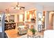 Open concept living room and kitchen area with hardwood floors and a dining table at 2929 Matoka Trl, Matthews, NC 28104