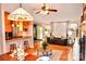 Open-concept living room with hardwood floors, ceiling fan, and cozy seating, creating a welcoming atmosphere at 2929 Matoka Trl, Matthews, NC 28104