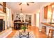 Open living and dining area featuring hardwood floors, a brick fireplace, and seating at the kitchen counter at 2929 Matoka Trl, Matthews, NC 28104