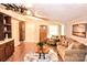 Open living room with a plush sofa, natural wood accents and plentiful cabinet space at 2929 Matoka Trl, Matthews, NC 28104
