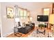 Cozy living room with a plush, reclining loveseat and stylish decor at 2929 Matoka Trl, Matthews, NC 28104