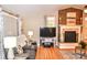 The living room features hardwood floors, a brick fireplace, and a comfortable couch for relaxing evenings at 2929 Matoka Trl, Matthews, NC 28104