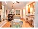 Bright living room with hardwood floors, brick fireplace, seating, and dining table with breakfast bar at 2929 Matoka Trl, Matthews, NC 28104