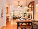 Open concept showing brick fireplace, hardwood floors, ceiling fan, and cozy seating in the living room at 2929 Matoka Trl, Matthews, NC 28104