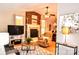 Cozy living room with brick fireplace, ceiling fan, hardwood floors, and comfortable seating arrangement at 2929 Matoka Trl, Matthews, NC 28104