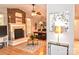This living room features a cozy brick fireplace, hardwood floors, and a dining area, perfect for entertaining at 2929 Matoka Trl, Matthews, NC 28104