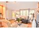 Open living room with hardwood floors, a reclining loveseat, and front door at 2929 Matoka Trl, Matthews, NC 28104