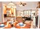 Open concept living space featuring a dining table, kitchen, and living room with fireplace at 2929 Matoka Trl, Matthews, NC 28104
