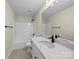 Bathroom with white cabinets, a marble countertop, and a shower-tub combo at 3012 Isle Ln, Monroe, NC 28110