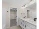 Bathroom with double sink vanity, quartz countertops, black hardware, and a walk in closet in the adjacent room at 3012 Isle Ln, Monroe, NC 28110