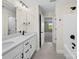 Bathroom with double sink vanity, quartz countertops, black hardware, and shower-tub combo at 3012 Isle Ln, Monroe, NC 28110