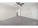 Spacious bedroom with plush gray carpet and ceiling fan at 3012 Isle Ln, Monroe, NC 28110