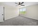 Cozy bedroom with a window, neutral walls, and gray carpet at 3012 Isle Ln, Monroe, NC 28110
